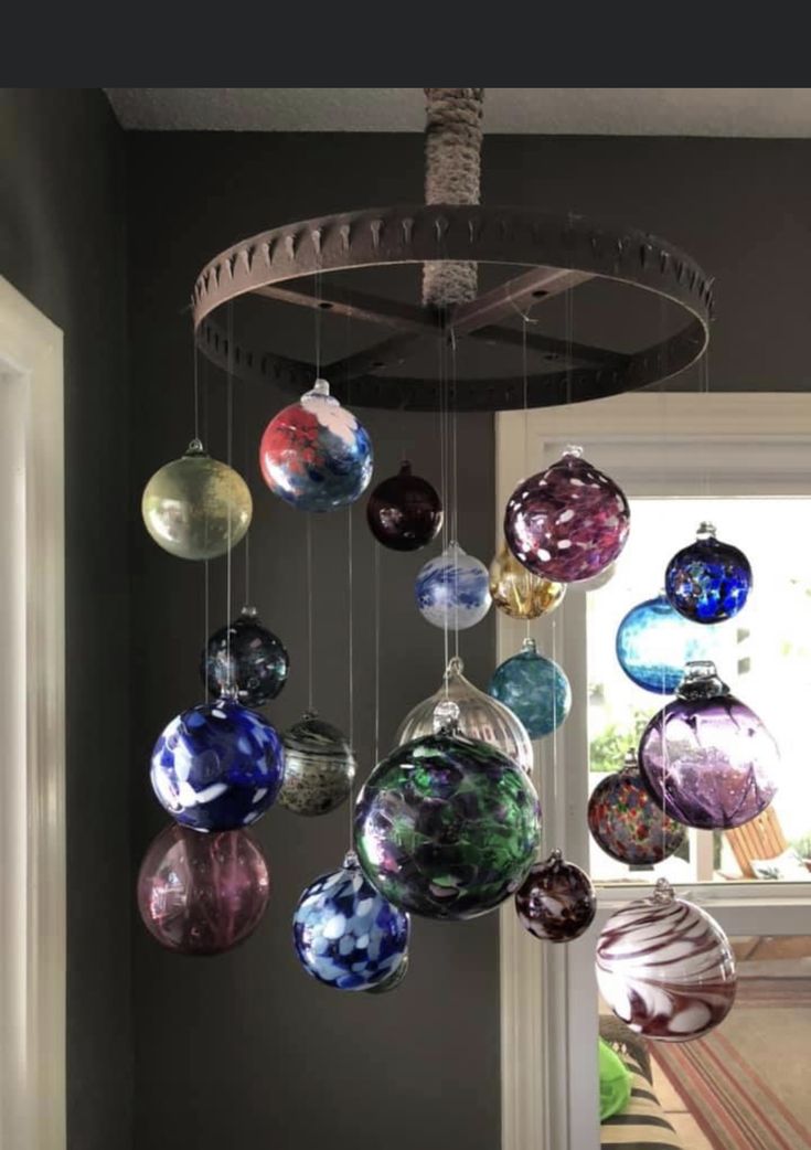 a chandelier with many different colored glass balls hanging from it's ceiling