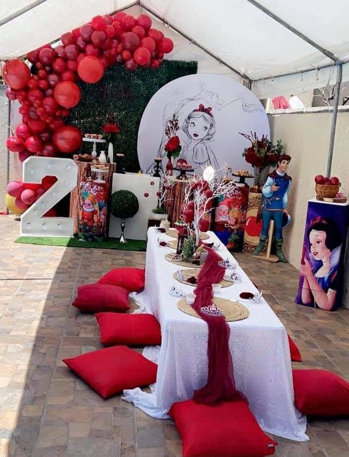 a table set up with red and white decorations