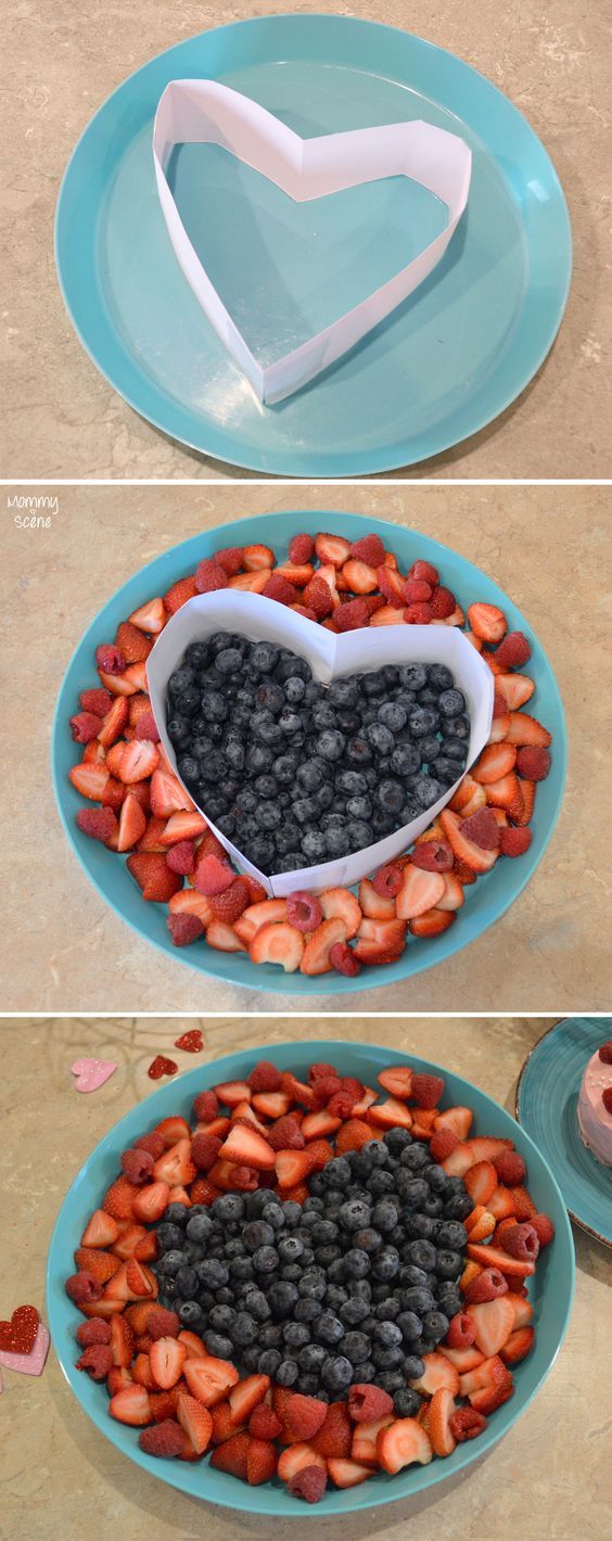 two plates with blueberries and strawberries in the shape of a heart