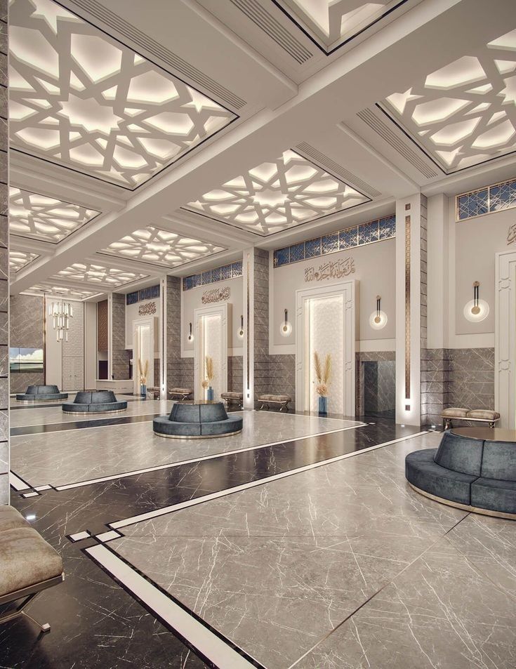 an empty lobby with marble floors and benches