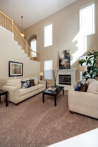 a living room with two couches and a coffee table in front of a fireplace