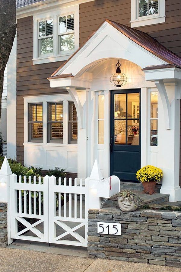 a house with a white picket fence and blue door