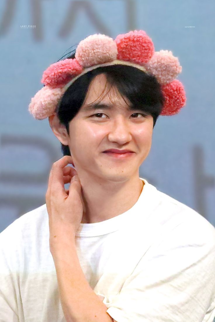 a young man wearing a hat with pom - poms on it's head