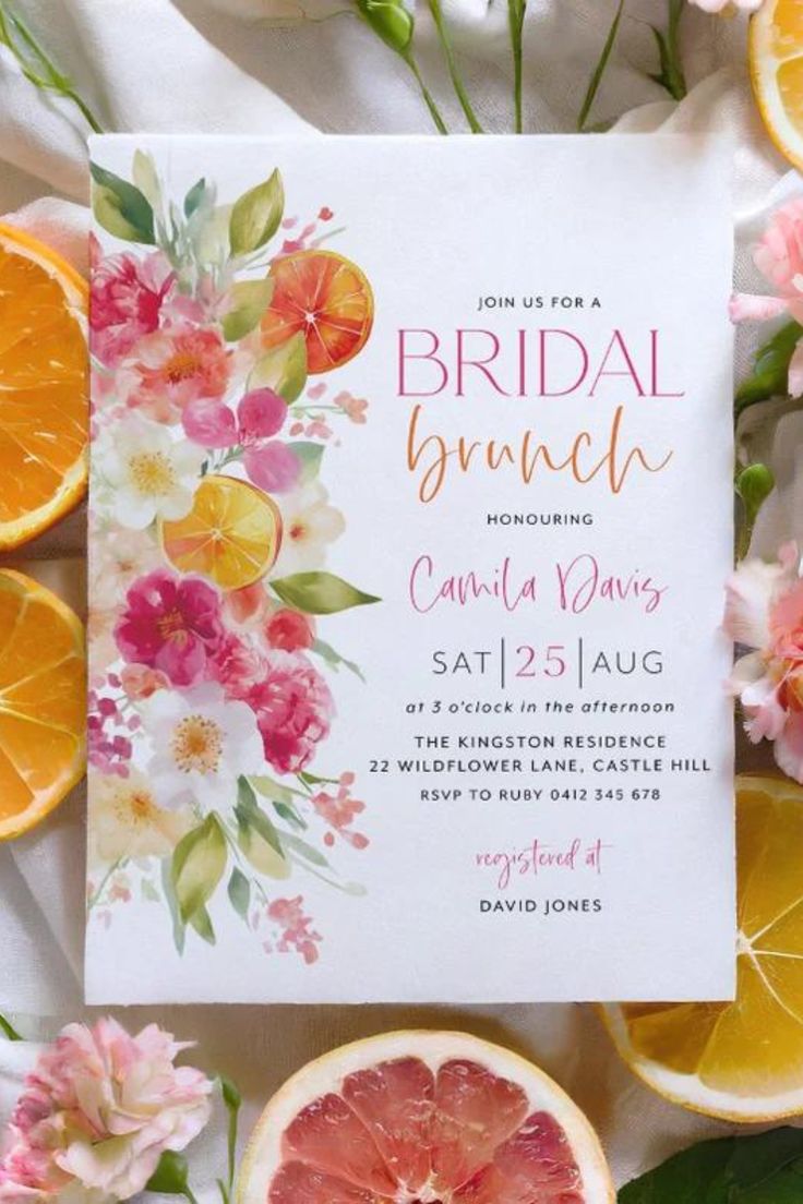 an orange and grapefruit brunch party is on the table with flowers