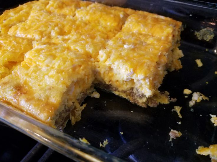 a close up of food in a pan on a stove top with one slice missing