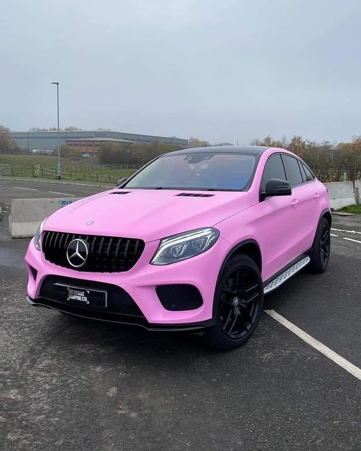 a pink mercedes suv parked in a parking lot