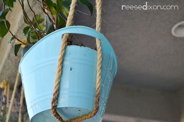 a blue bucket hanging from a rope