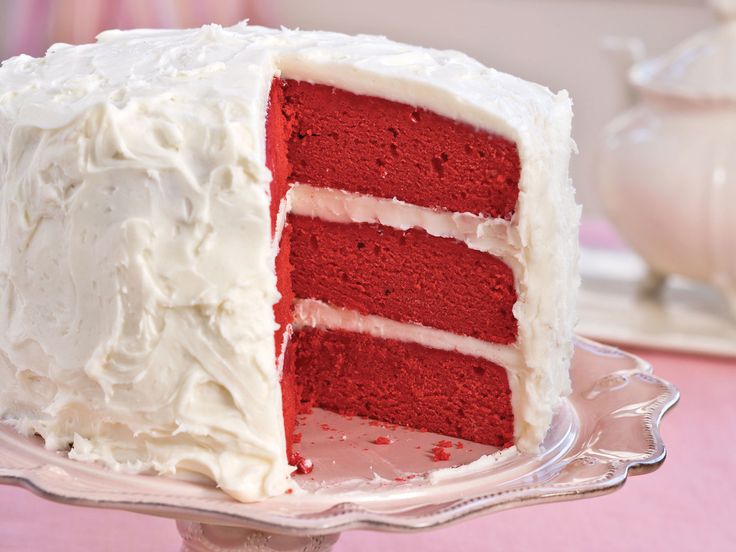 a red velvet cake with white frosting on a plate