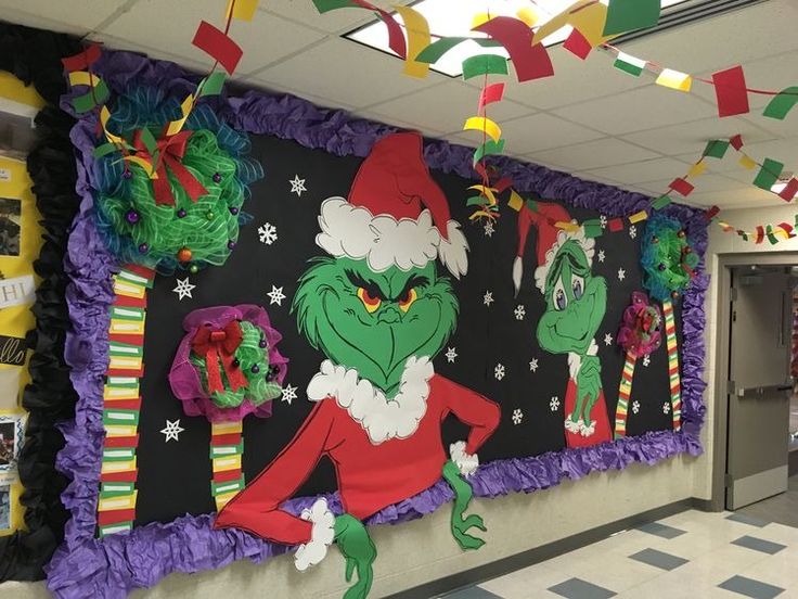 an bulletin board decorated with the grin's christmas decorations