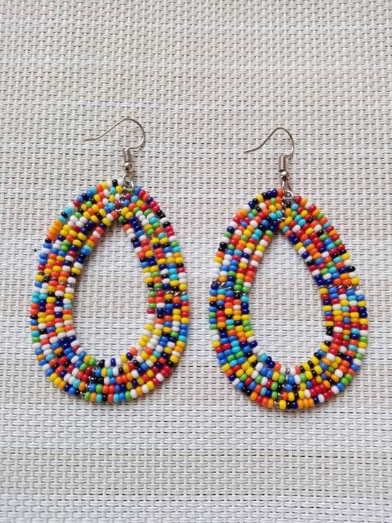 Circle Earrings | Custom Earrings | Hoop Earrings | Dainty Earrings | Beaded Earrings | Moms Gift | Gift Ideas | Unique Gift These eye catching  earrings are superbly crafted and can be worn with any outfit.The earrings are very light to wear.Main Color - multi color.The earrings measure 3 inches from top of the hook.**Buy multiple items and pay shipping for 1 item only.The rest ships free.Feel free to send me a convo or e-mail for any clarification or wholesale pieces.Thank you for visiting... Cheap Multicolor Beaded Earrings For Gifts, Multicolor Teardrop Hoop Earrings, Multicolor Handmade Beaded Earrings, Handmade Multicolor Round Beads Earrings, Multicolor Teardrop Hoop Earrings With Dangling Beads, Colorful Beads Teardrop Jewelry For Crafting, Traditional Small Hoop Multicolor Earrings, Unique Multicolor Beaded Hoop Earrings, Traditional Multicolor Small Hoop Earrings