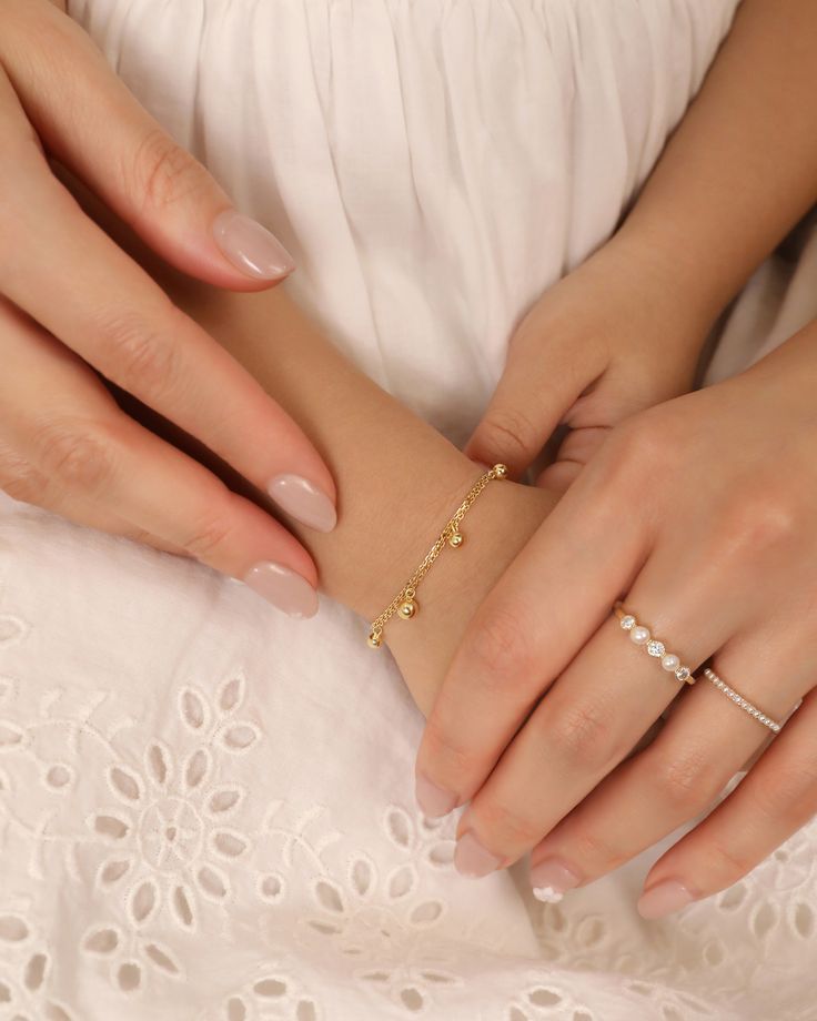 An adult's hands are holding the baby's hands, The child is wearing a gold beaded bracelet and the woman is wearing two gold pearl rings. Simple Pearl Ring, Pearl Ring Simple, Gold Pearl Ring, Stackable Jewelry, Simple Pearl, Gold Colors, Unique Jewelry Designs, Matching Rings, Stackable Ring