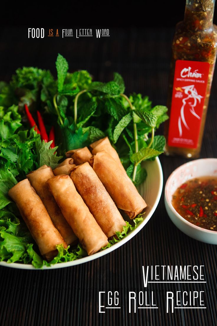 vietnamese egg roll recipe on a plate with dipping sauce next to it and a bottle of hot sauce