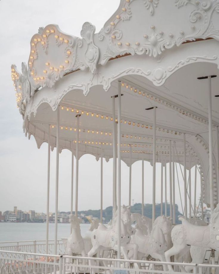 a white merry go round with lights on it