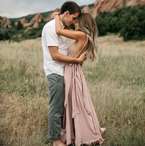 a man and woman embracing in a field