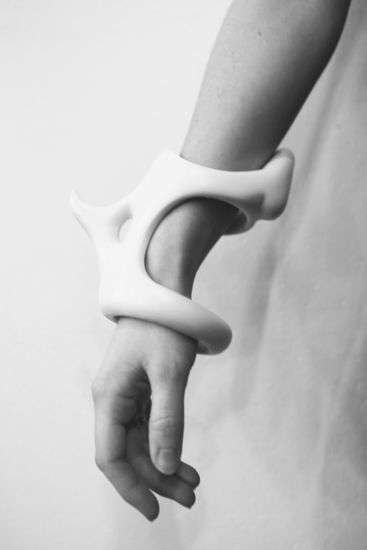 black and white photograph of a person's arm with an object in the middle