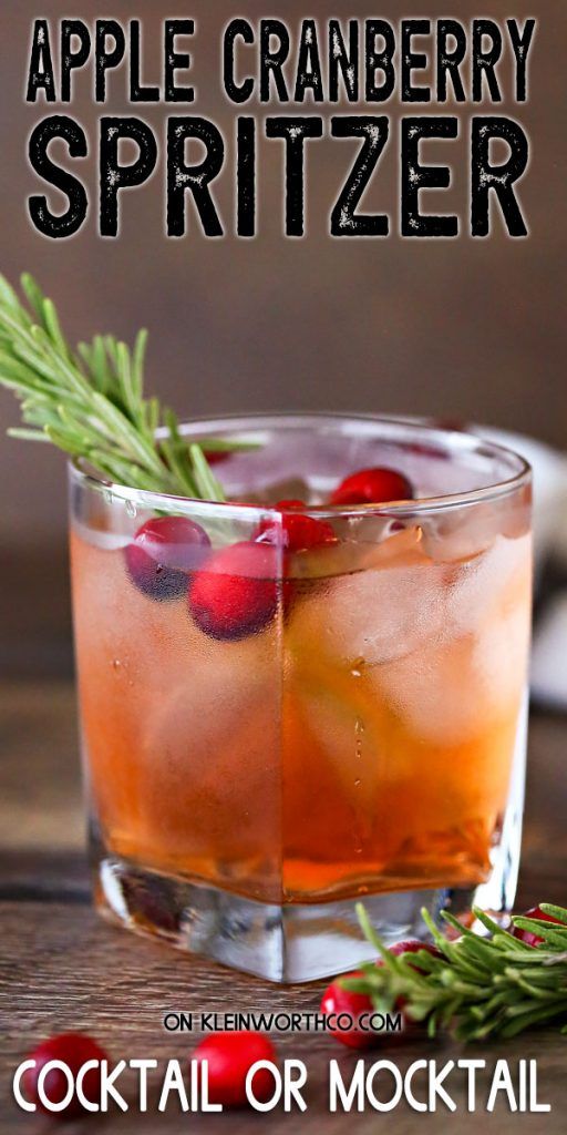 an apple cranberry spritzer in a glass with ice and garnish