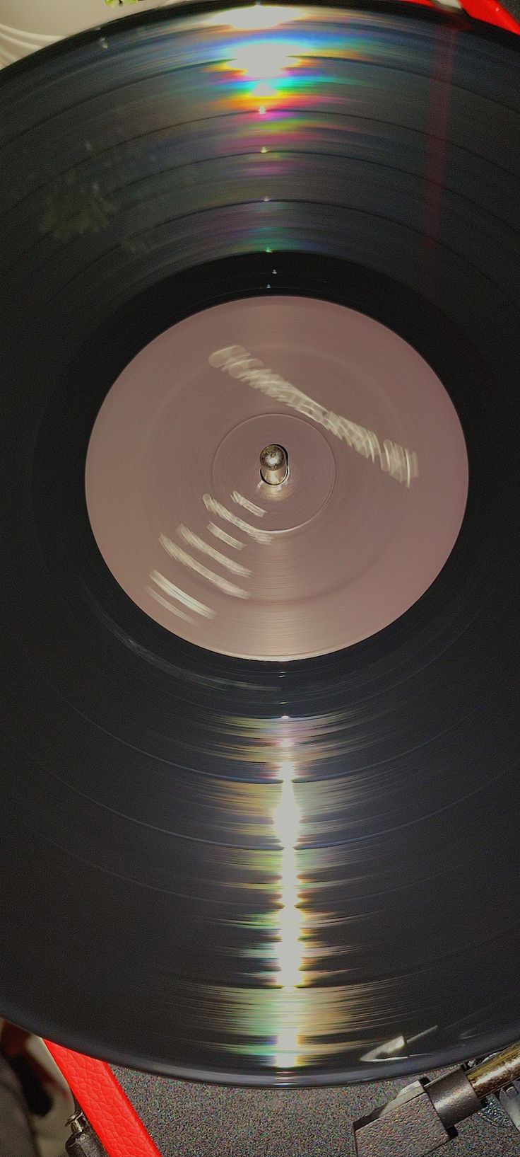 an old record player with its turntable spinning on it's side in the sun