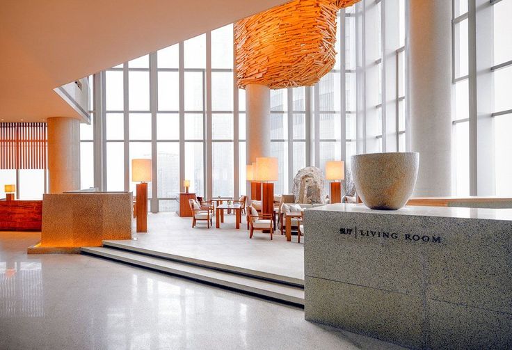 the interior of an office building with large windows and modern furnishings on display in front of them