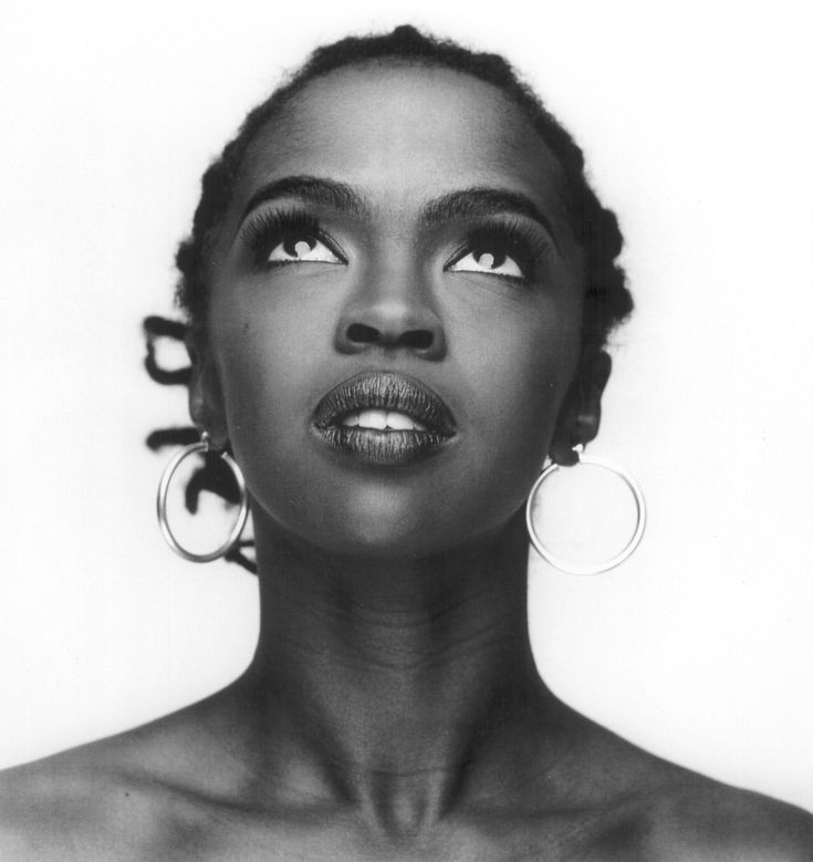 a black and white photo of a woman with large hoop earrings