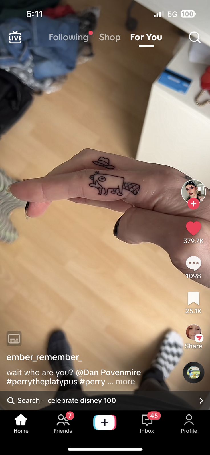 a person's hand with the word love written on it and an arrow tattoo