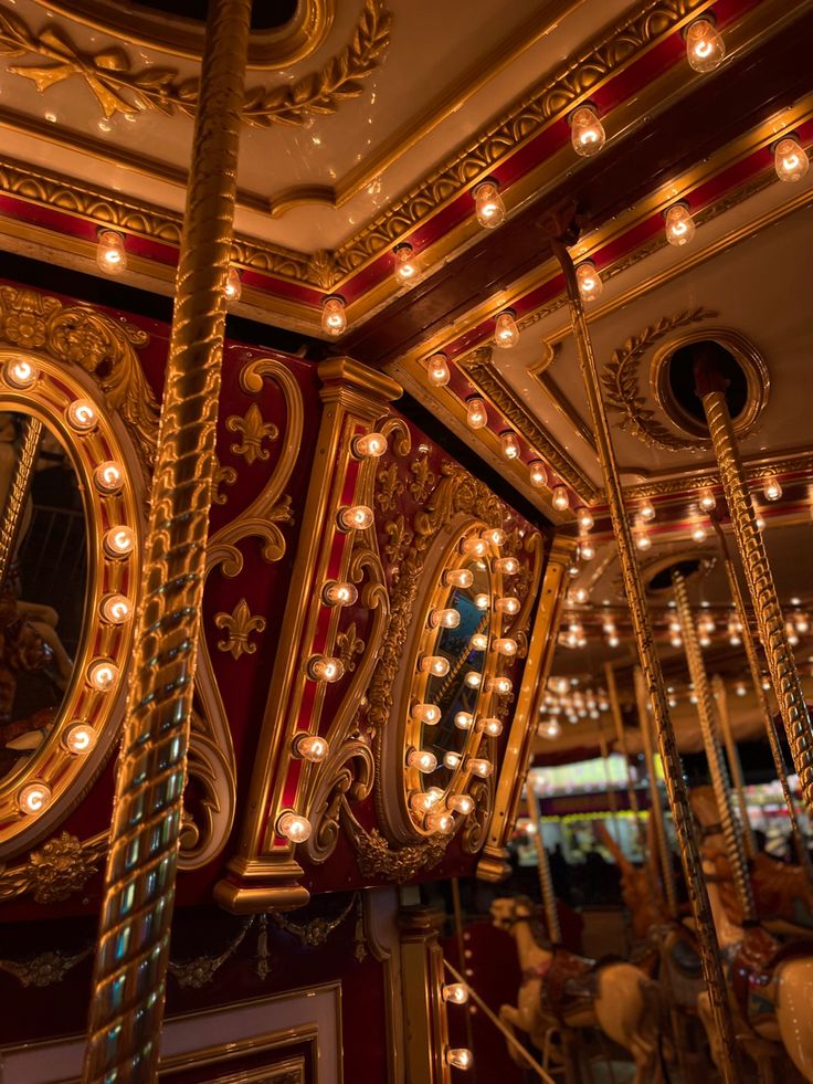 an ornately decorated carousel with mirrors and lights