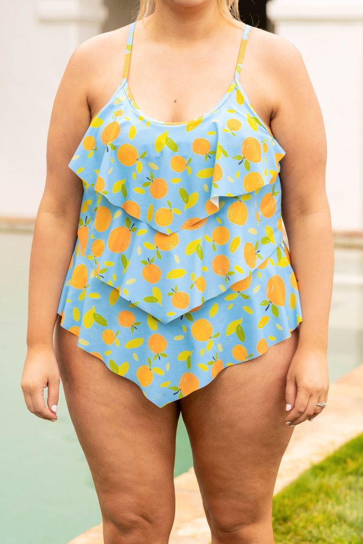 This swimsuit is calling your name! This chic swimmie has a fun orange print you can wear with your favorite cover-ups and sandals! It's comfortable for all day wear, has a figure-flattering one-piece design, and features the cutest ruffles along the body! Wear this swimsuit all season long! 82% Polyamide, 18% Elasthane Orange Tankini For Summer Beach Party, Orange Summer Swimwear For Sunbathing, Orange Summer Tankini For Poolside, Orange Summer Tankini For Vacation, Orange Summer Swimwear For Poolside, Orange Tankini For Summer Vacation, Orange Swimwear For Summer Beach Party, Orange Swimwear For Poolside Summer, Fun Sleeveless Tankini For Swimming