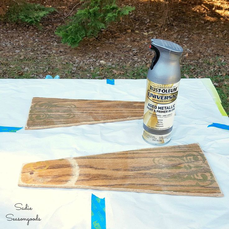 a bottle of glue sitting on top of some wood planks next to a pair of scissors