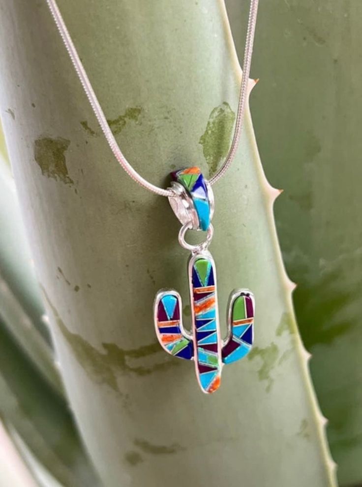 Saguaro cactus pendant inlaid with multi stones set in sterling silver. Opal makes these pretty earrings glisten and catch the sun. This pretty saguaro necklace has inlaid blue turquoise, lapis, spiny oyster, and opal.  Saguaro pendant hangs on an 18 inch sterling silver chain. The one that is left has the thicker chain. I also have small dangling saguaro earrings that match and another saguaro pendant necklace that is green turquoise and opal only. Desert Jewelry, Cactus Jewelry, Vert Turquoise, Saguaro Cactus, Sonoran Desert, Southwest Style, Spiny Oyster, Pretty Earrings, Small Earrings