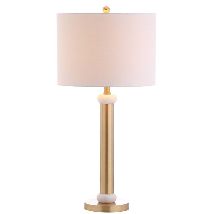 a white lamp with a gold base and a light shade on the top of it