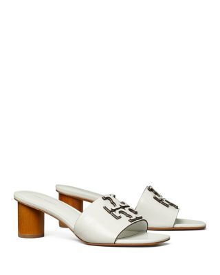 Tory Burch Women's Ines Mule Sandals Luxury Open Toe Sandals With Wooden Heel, Luxury Tan Sandals For Spring, Designer Sandals With Wooden Block Heel, Luxury Summer Mules With Wooden Heel, Luxury Mules With Wooden Heel For Summer, Designer Sandals With Wooden Heel, Luxury Tan Heels For Summer, Elegant Tan Sandals With Leather Sole, Luxury Tan Open Toe Sandals