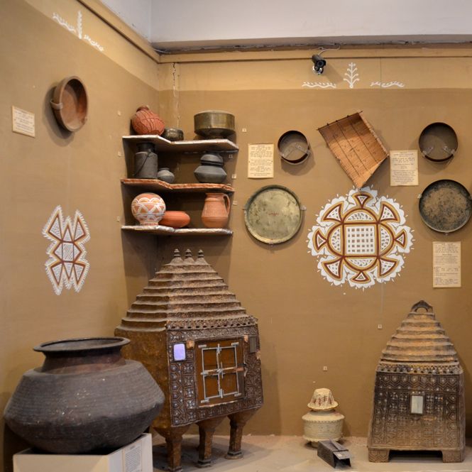 an assortment of pots and pans on display in a room