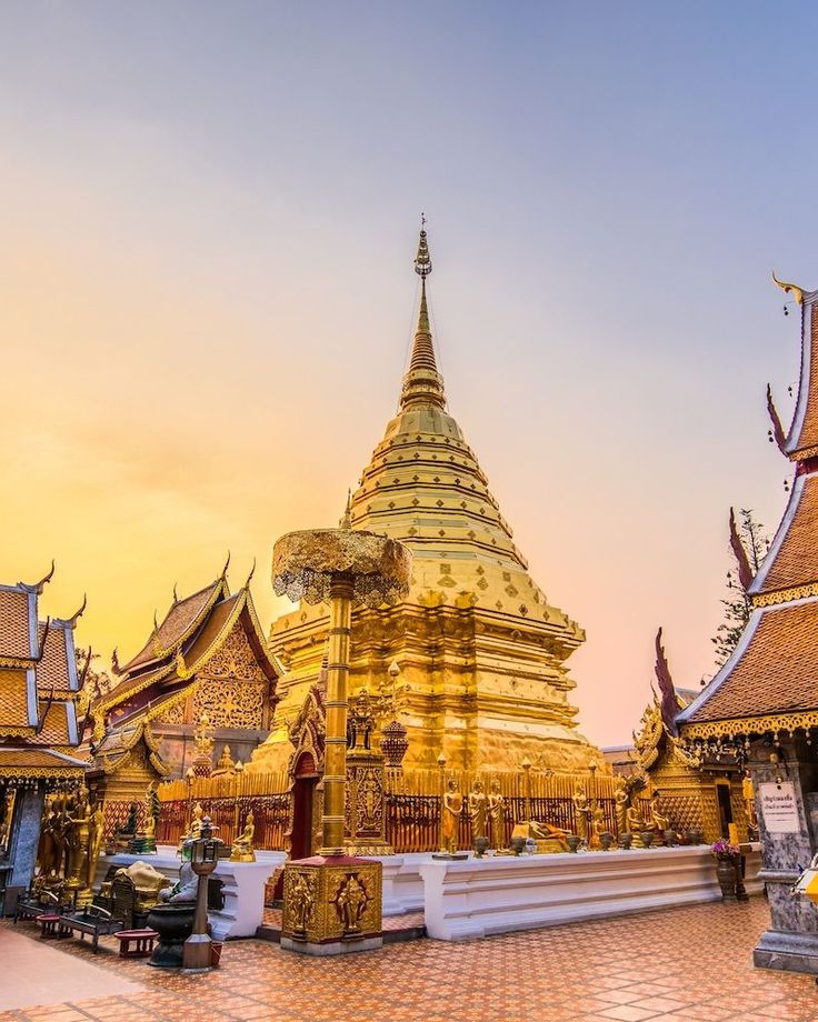 the golden temple is surrounded by many other buildings and structures, including an elaborately designed roof