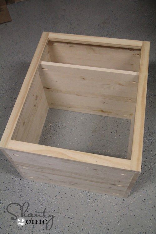 a wooden box sitting on top of a cement floor