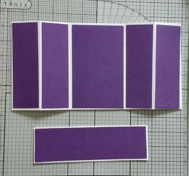 three pieces of purple fabric sitting on top of a cutting mat