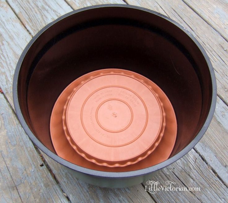 a brown bowl sitting on top of a wooden table