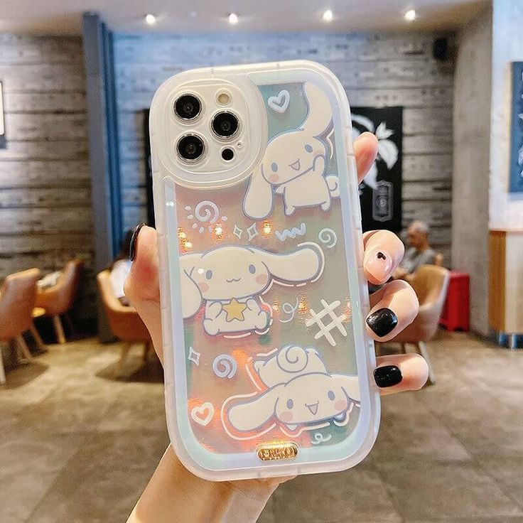 someone is holding up their phone case with cartoon animals on it in front of the camera