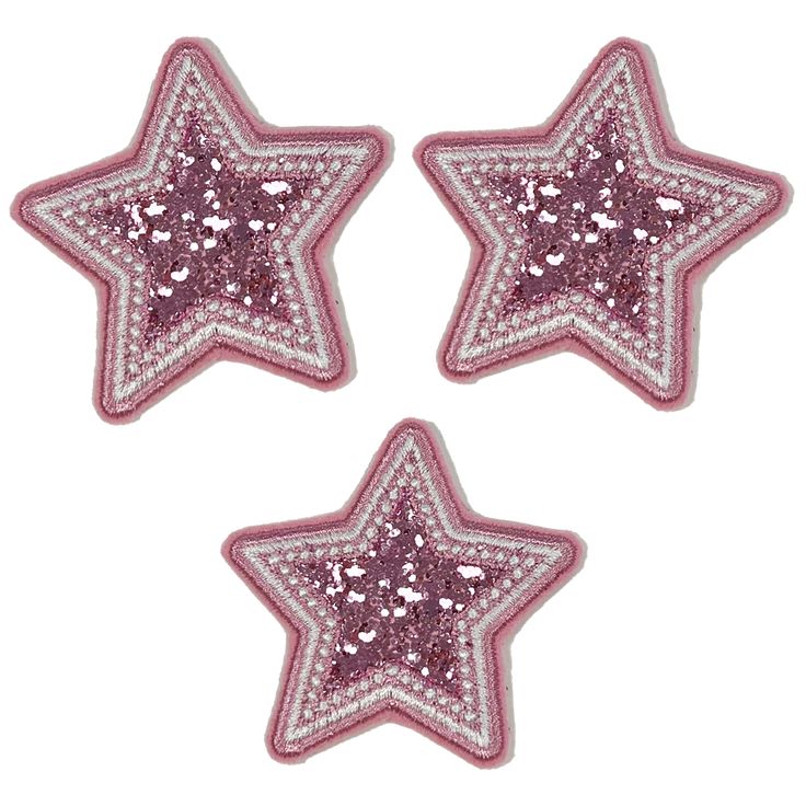 three pink and white stars with sequins on them