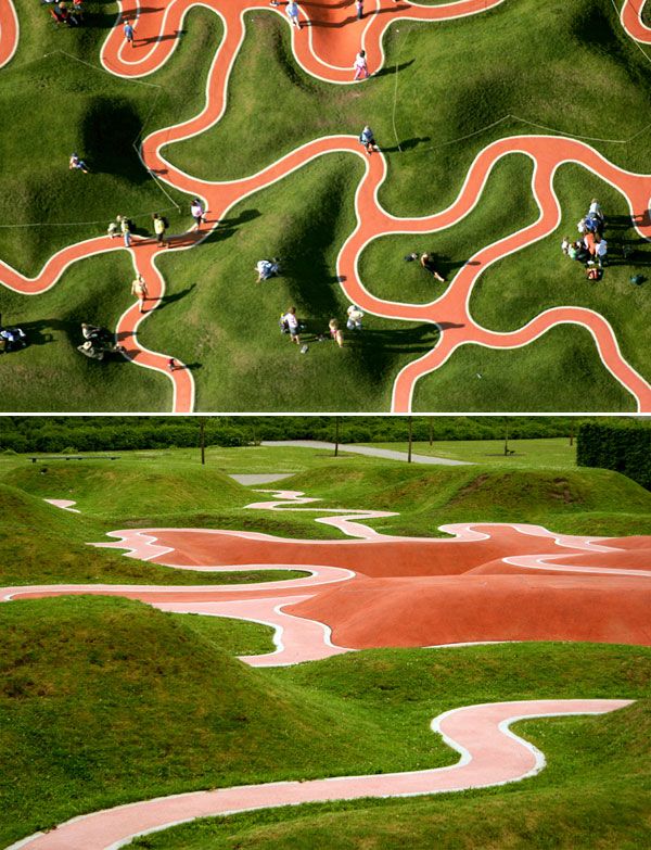 an aerial view of a park with many different paths and people walking on the grass