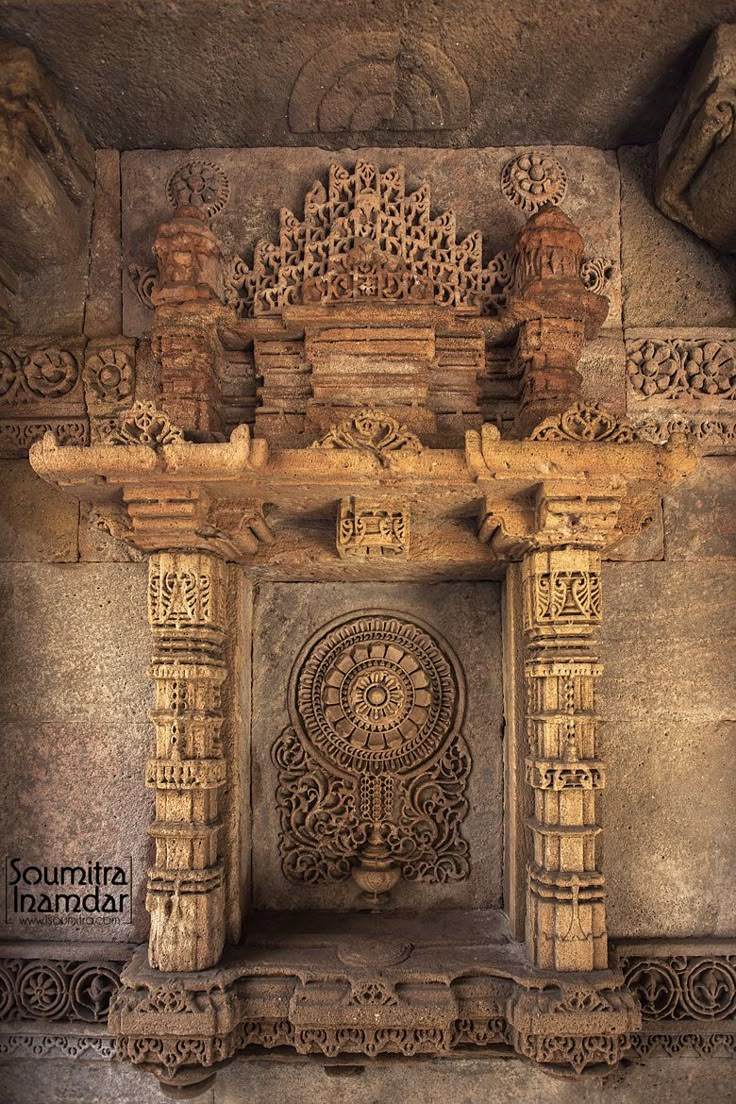 an intricately carved stone arch in the middle of a building