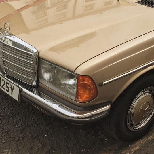 an old mercedes benz parked on the street