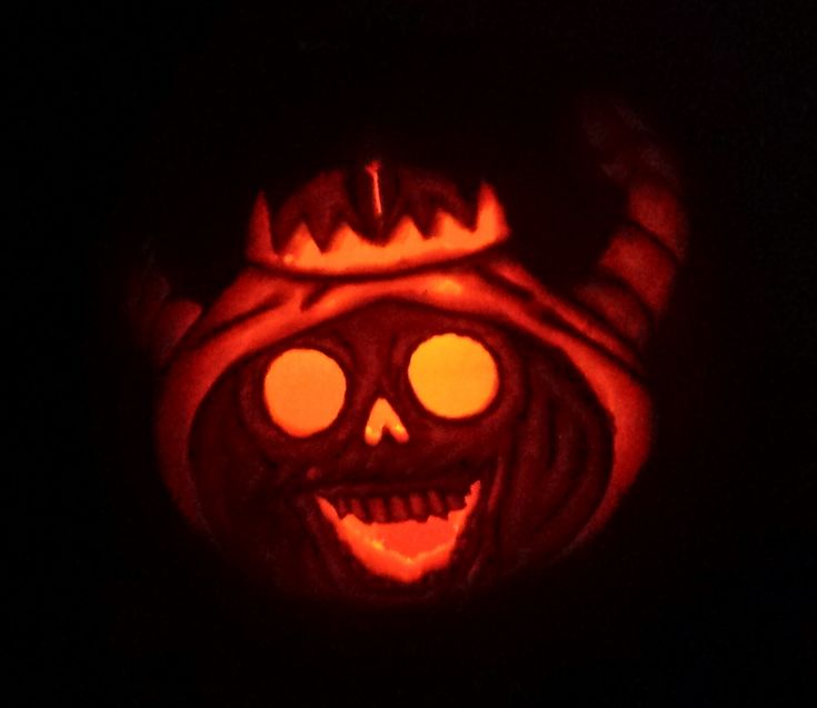 a pumpkin carved to look like a demon