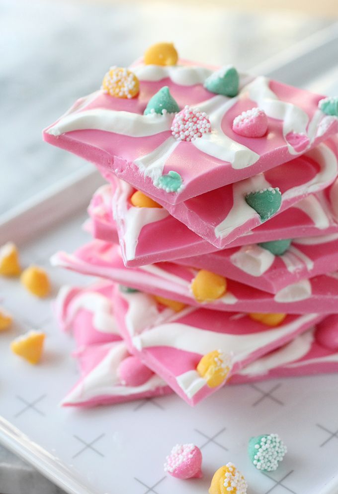 a white plate topped with pink and yellow candy