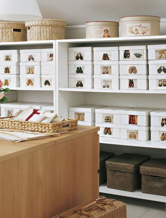 a room filled with lots of white boxes and baskets