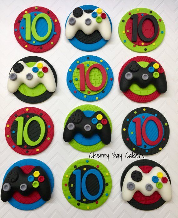 a set of ten decorated cookies with video game controllers on them for 10th birthday party