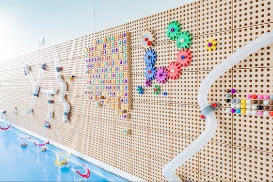 the wall is decorated with many different colored beads and plastic sprinkles on it