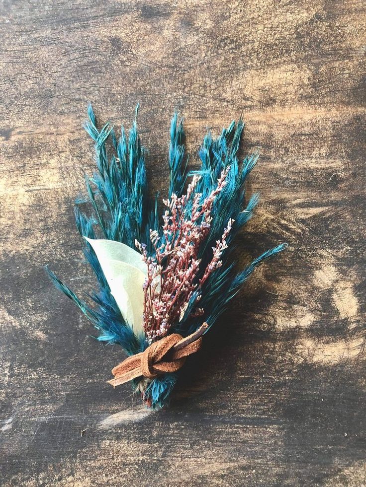 a bunch of blue feathers sitting on top of a wooden table