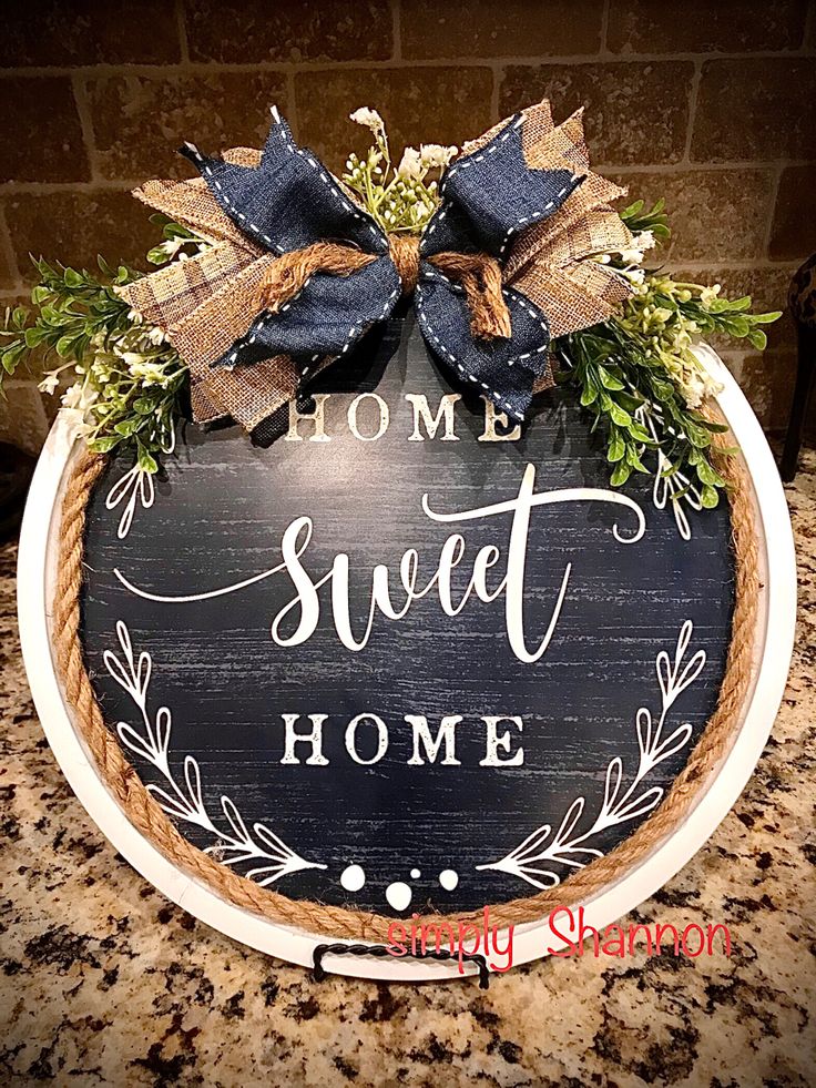 a sign that says home sweet home on the side of a kitchen counter with bows