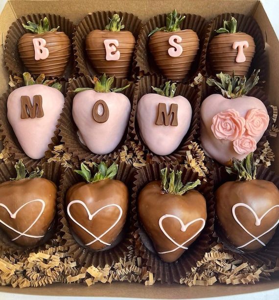 a box filled with chocolate covered strawberries in the shape of hearts