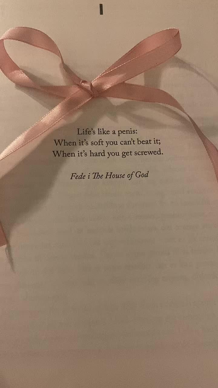 an open book with a pink ribbon tied around it and a poem written on the page