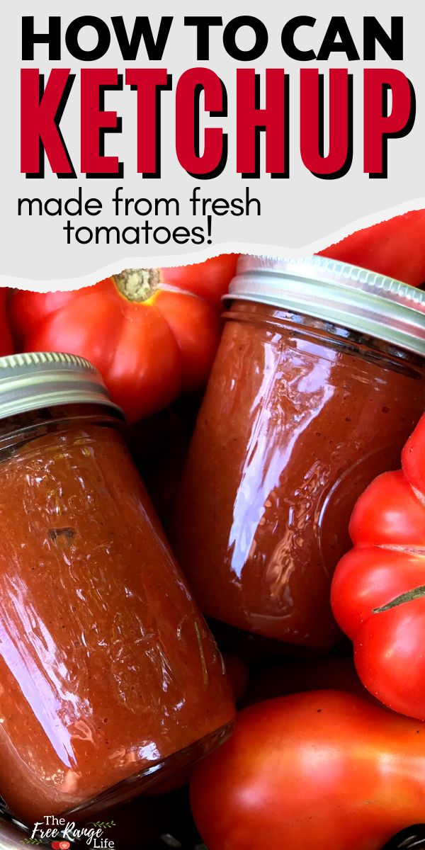 two jars filled with ketchup sitting on top of tomatoes